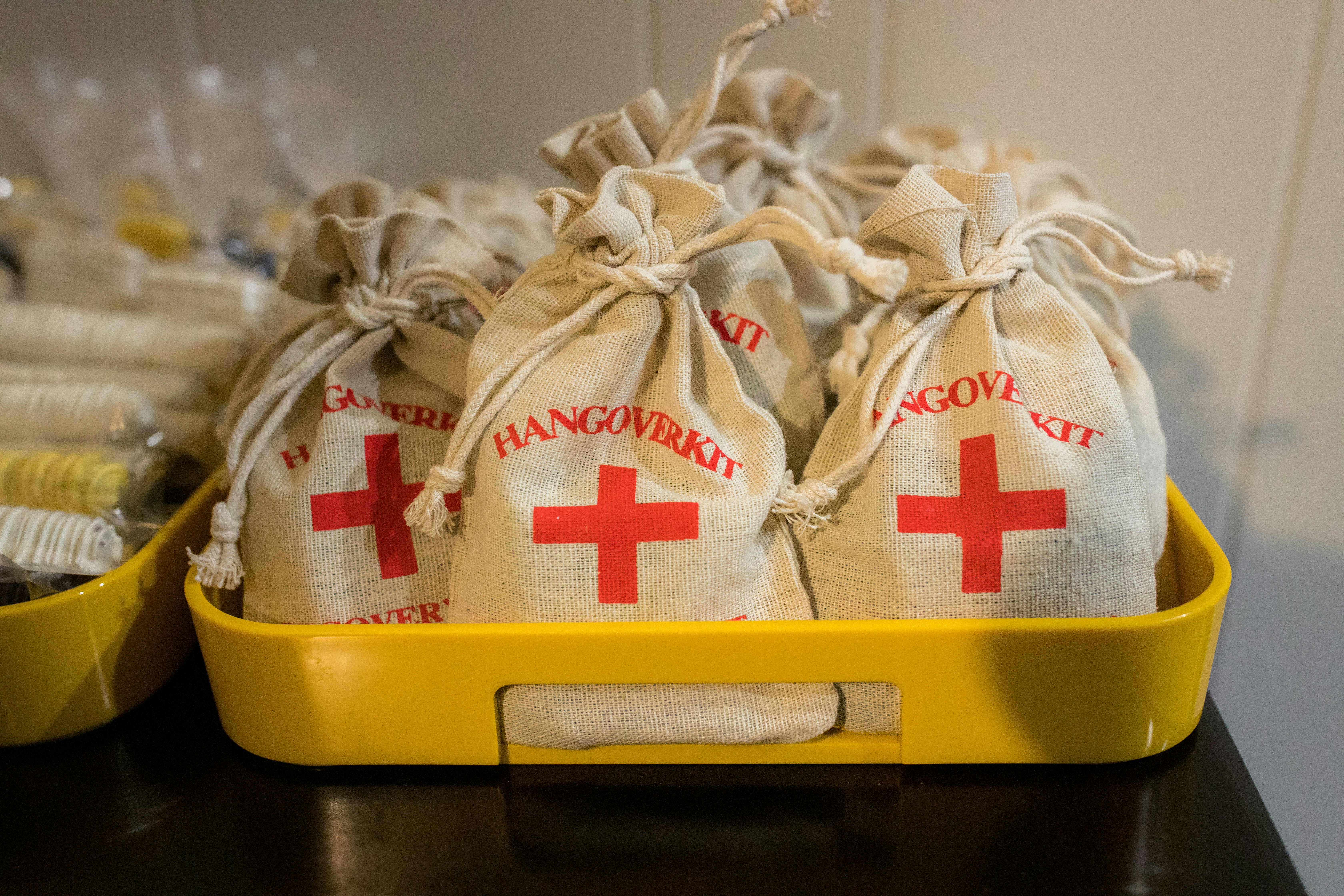 white and red textile on yellow plastic container